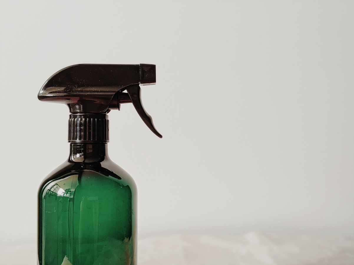 Spray bottle on white background